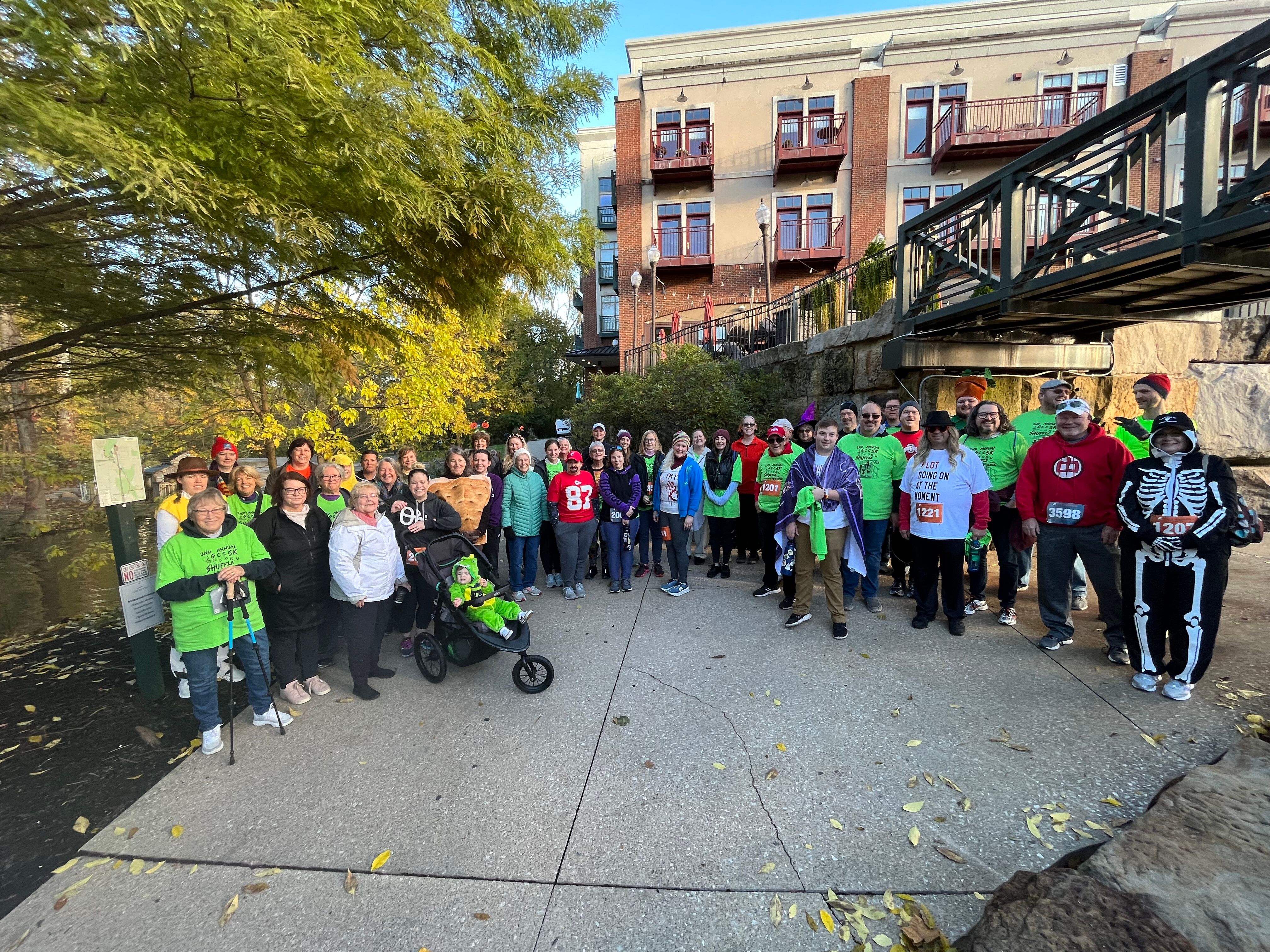 wide shot image of the all the runners of the spooky shuffle 5k dressed up in costumes ready to run
